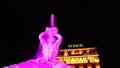 Night long exposition of the triton of the homonymous fountain lit with pink headlights