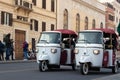 Rome, Italy - March 17th, 2022. Two white and red Calessino Ape Piaggio cars touring the city of Rome, Italy Royalty Free Stock Photo