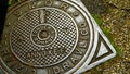 Cast iron manhole cover with Italian writing HYDRAULIC SERVICE, and SPQR of the municipality of Rome, in the morning sun Royalty Free Stock Photo
