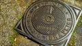 Cast iron manhole cover with Italian writing HYDRAULIC SERVICE, and SPQR of the municipality of Rome Royalty Free Stock Photo