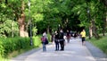 People stroll, run and ride bicycles in the public park