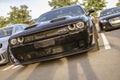 Powerful black dodge challenger srt hellcat showing its aggressive front design Royalty Free Stock Photo