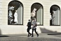 ROME,ITALY-MAY 12: two unknown African men in medical mask walk in front of closed shop near Spanish Steps in Italian lockdown