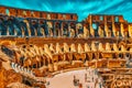 ROME, ITALY - MAY 08, 2017 : Tourist`s Inside the amphitheater of Coliseum in Rome- one of wonders of the world  in the morning Royalty Free Stock Photo