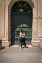 Two young women near the famous keyhole of the Gardens of Order of Malta on Aventine Hill in Rome, Italy Royalty Free Stock Photo