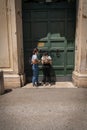 Two young women near the famous keyhole of the Gardens of Order of Malta on Aventine Hill in Rome, Italy Royalty Free Stock Photo