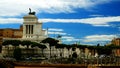 View of the Victorian from behind an ancient wall. also called Altare della Patria located in Piazza Venezia in Rome Royalty Free Stock Photo