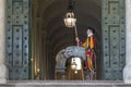 A member of the Swiss Guard stands guard in front of the Portone Di Bronzo in Rome`s St. Peter`s Square Royalty Free Stock Photo