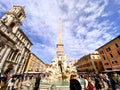 Crowd of people enjoying a sunny autumn day walking near the famous fountain of the four rivers in the center of Piazza Navona in