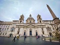 Facade of the baroque church of Sant`Agnese in Agone in Piazza Navona, in the historic center of Rome in with people strolling on Royalty Free Stock Photo