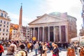 People walking on the square of the famous Pantheon temple of all the gods is a former Roman temple with bright sun rays