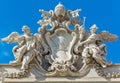 The Papal coat of arms of Clement XII crowns the facade of the Trevi Fountain in Rome