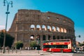 Rome, Italy. Colosseum. Red Hop On Hop Off Touristic Bus For Sightseeing In Street Near Flavian Amphitheatre. Famous Royalty Free Stock Photo