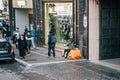 Rome, Italy - October 2019 : Homeless man sitting on Europe street, people pass by, problem of beggars and emigrants Royalty Free Stock Photo