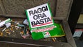 protest flyer of the Democratic Party against the mayor of Rome Virginia Raggi, abandoned in a trash can