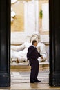 Security guard officer in front of colossal statue of Neptune in Palazzo Nuovo