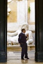 Security guard officer in front of colossal statue of Marforio in Palazzo Nuovo