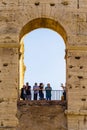 Silhouettes of group of people in Colosseum`s arch in Rome, Italy