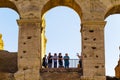 Silhouettes of group of people in Colosseum`s arch in Rome, Italy