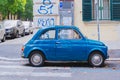 Rome, Italy - A quirky Fiat 500 in shiny blue, a common automobile seen in the streets of the capital due to the lack of space for