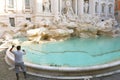 ROME, ITALY - SEPTEMBER 16, 2019: city worker collecting money and doing special cleaning of Trevi Fountain in Rome, Italy