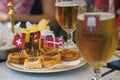 Rome, Italy - September 16 2019: Glasses of beer and small pizzetas as apperizer. Appetizers and Snacks decorated with european