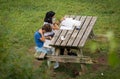 Mother in medical mask and her son doing homework in garden at table in Rome during second wave of coronavirus epidemic covid 19 Royalty Free Stock Photo