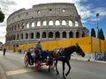 Tourists next to the Colosseum, a famous historical landmark in Rome, Italy