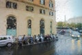 ROME, ITALY - September 15:View on the people with umbrellas and cars on street of Rome on the rainy and day through wet glass.