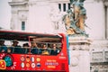 Rome, Italy. Tourists In Red Hop On Hop Off Touristic Bus For Sightseeing In Street Near Altar Of The Fatherland On Royalty Free Stock Photo