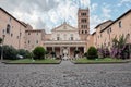 Rome, Italy, Tourists relax on the parapet of the fountain in the courtyard of the basilica