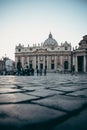 Tourists stroll around the square in front of St. Peter`s in the