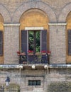 Rome, Italy, vintage house balcony with potted flowers. Royalty Free Stock Photo