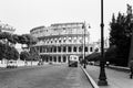 1966, Rome, Italy - Vintage people and cars drive along Via dei Fori Imperiali near the Colosseum