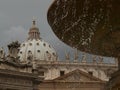 Piazza San Pietro fountain in Rome with the dome and a detail of the church Royalty Free Stock Photo