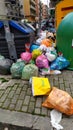 Sidewalk covered in garbage and garbage bags near the bins on a street in Rome