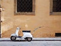 Rome - 26 May 2016 - Traditional White Moped on Rusitc Italian Street in Rome, Italy