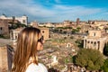 Rome - Woman with panoramic view on the Roman Forum and Rome Skyline from the Palatine Hill in the ancient city of Rome, Lazio Royalty Free Stock Photo