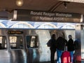 Ronald Reagan Washington National Airport wmata meto train subway stop with train moving and passengers waiting to board