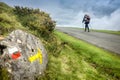 Roncesvalles, Spain - Trail Signs and a Woman Pilgrim Trekking across Pyrenean Mountains along the Way of St James