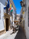 RONDA, ANDALUCIA, SPAIN - MAY 8 : Tourists enjoying a ride in a horse drawn carriage in Ronda Spain on May 8, 2014. Three Royalty Free Stock Photo
