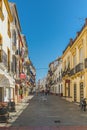 Ronda, Andalusia, Spain. tourists pass to the New Roman Bridge along a shopping street