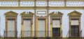 Front view of typical and classic building and windows with blinds and tiles in Ronda