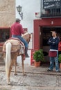 Man riding horse on street of Ronda, Spain