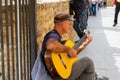 Street musician near Puente Nuevo Bridge at sunset in Ronda, Spain on October 23, 2022