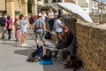 Street musician near Puente Nuevo Bridge at sunset in Ronda, Spain on October 23, 2022