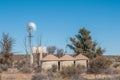 Rondavels next to a windpump and water storage tanks Royalty Free Stock Photo