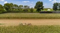 Aerial View of Six Horses Pulling an Amish Harvesting Corn Stalk Machine, as a Steam Passenger Train Travels Bye