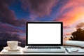 Ront view of cup and laptop on table in office and background at the sky mountain river and trees front view background