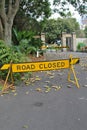 A rooad closure sign blocking the road